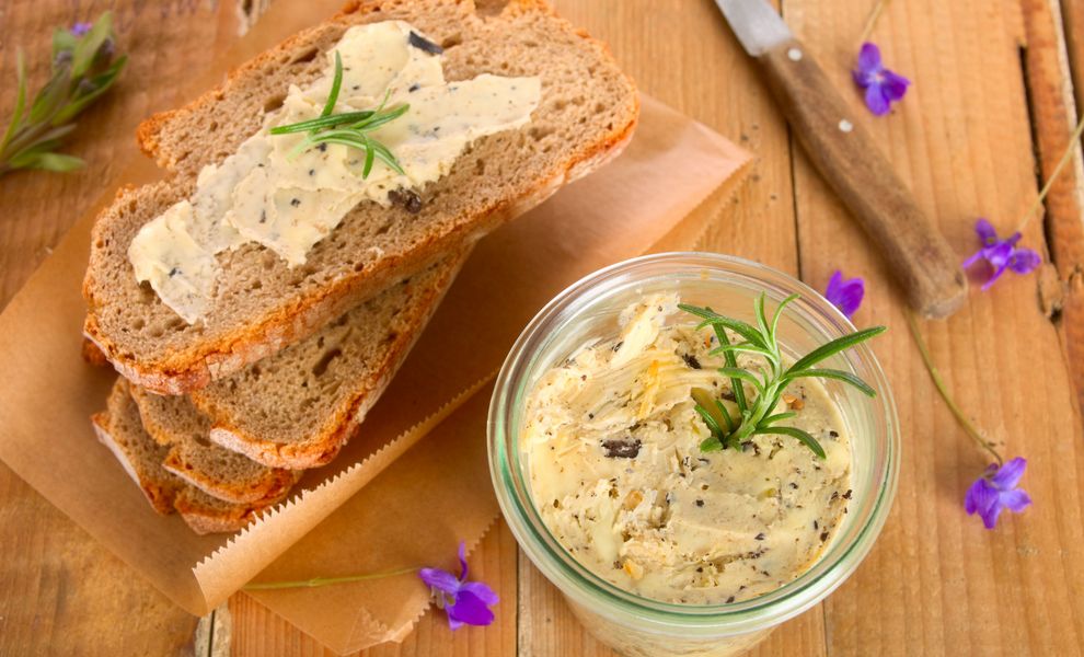 Kräuterbutter mit Brotscheiben angerichtet