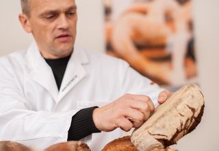 Prüfer klopft auf Brot